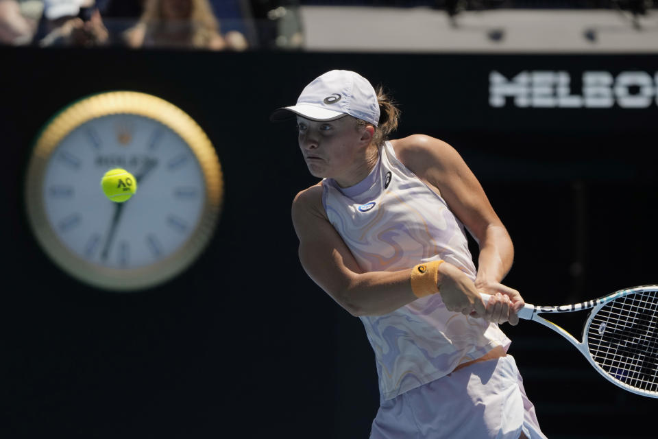 Iga Swiatek of Poland plays a backhand return to Elena Rybakina of Kazakhstan during their fourth round match at the Australian Open tennis championship in Melbourne, Australia, Sunday, Jan. 22, 2023. (AP Photo/Mark Baker)