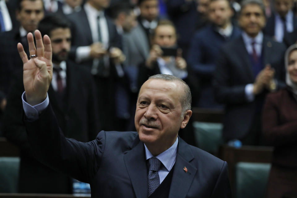 Turkey's President Recep Tayyip Erdogan waves as he arrives to deliver a speech to MPs of his ruling Justice and Development Party (AKP) at the parliament in Ankara, Turkey, Tuesday, Jan. 8, 2019. Erdogan said Turkey's preparations for a new military offensive against terror groups in Syria are "to a large extent" complete. Erdogan made the comments just hours after U.S. national security adviser John Bolton met with Turkish officials seeking assurances that Turkey won't attack U.S-allied Kurdish militia in Syria. (AP Photo/Burhan Ozbilici)
