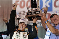 AJ Allmendinger, left, is presented with his trophy after winning a NASCAR Xfinity Series auto race at Bristol Motor Speedway Friday, Sept. 17, 2021, in Bristol, Tenn. (AP Photo/Mark Humphrey)