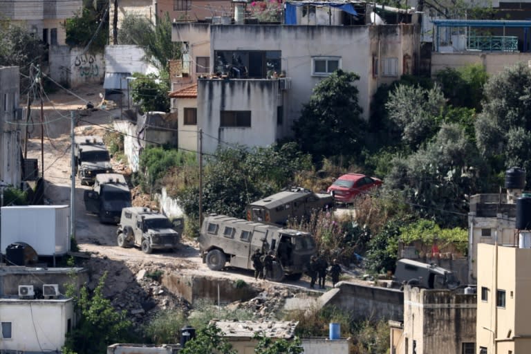 Israeli soldiers line up during a raid in the Nur Shams refugee camp in the occupied West Bank (Zain JAAFAR)