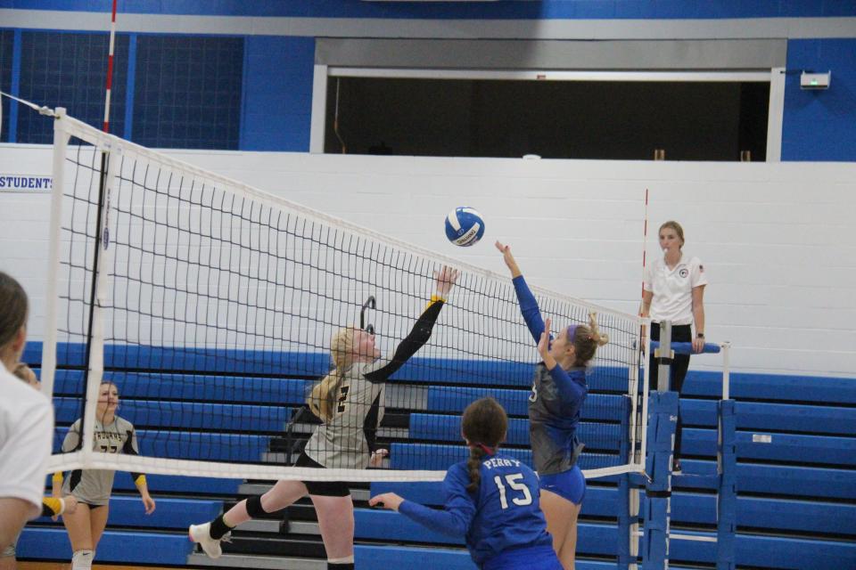 Perry's Maci Tunink goes up at the net against West Marshall on Thursday, Sept. 22, 2022, in Perry.