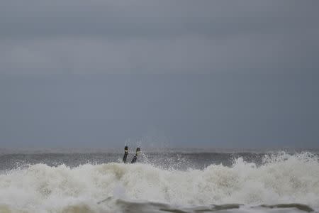 A surfer succumbs to a wave on rough sea where the tide should be out on the eve of the arrival of storm Ophelia in the County Clare town of Lahinch, Ireland October 15, 2017. REUTERS/Clodagh Kilcoyne