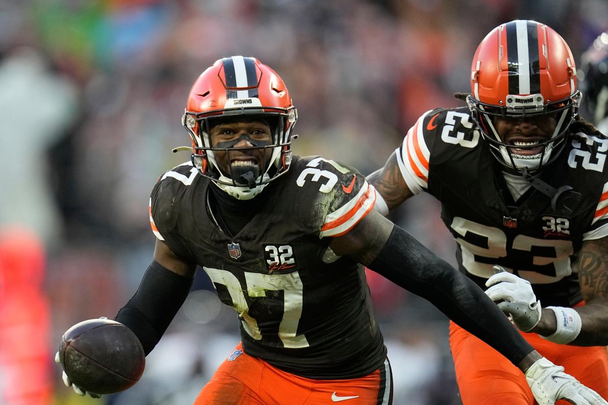 Cleveland Browns safety D'Anthony Bell (37) and Cleveland Browns cornerback Martin Emerson Jr. (23) celebrate against the Chicago Bears in Cleveland on Dec. 17, 2023.