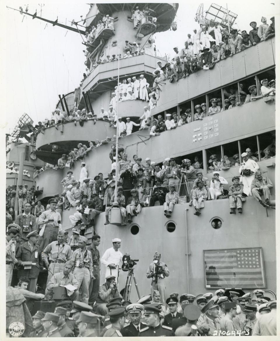 Journalists and spectators gather on the deck and superstructure of the USS Missouri on Sept. 2, 1945, in Tokyo Bay to witness and document the formal surrender of Imperial Japan at the end of World War II.