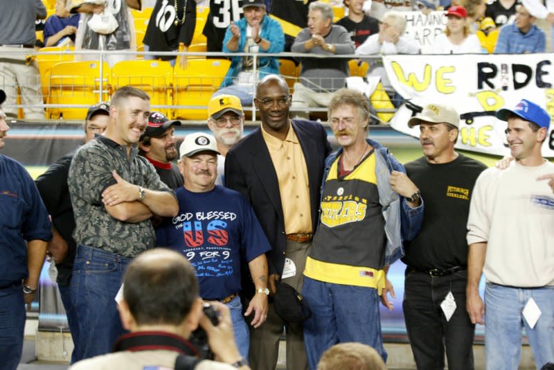 Former Pittsburgh Steeler and Hall of Famer John Stallworth poses for photos with members of the nine rescued Quecreek miners before the start of the Pittsburgh Steelers and Oakland Raiders football game on at Heinz Field on September 15, 2002. Nine miners were rescued July 28, 2002. File Photo by Stephen Gross/UPI