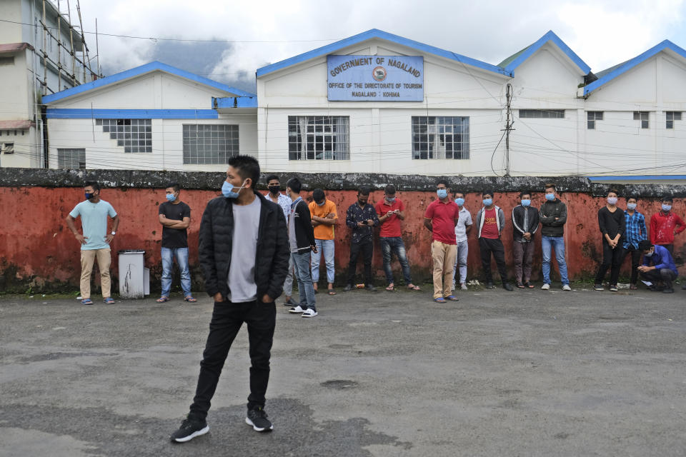 People wearing face masks as a precautionary measure against the coronavirus wait to test for COVID-19 in Kohima, capital of the northeastern Indian state of Nagaland, Saturday, Oct. 10, 2020. India’s total coronavirus positive cases near 7 million with another 73,272 infections reported in the past 24 hours. The Health Ministry on Saturday put the total positive caseload at 6.97 million, second to 7.66 million infections registered in the worst-hit United States. (AP Photo/Yirmiyan Arthur)