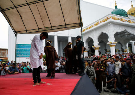 An Indonesian man is publicly caned for having gay sex, in Banda Aceh, Aceh province, Indonesia. REUTERS/Beawiharta