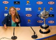 Germany's Angelique Kerber reacts next to the women's singles trophy during a news conference after winning her final match against Serena Williams of the U.S. at the Australian Open tennis tournament at Melbourne Park, Australia, January 30, 2016. REUTERS/Thomas Peter