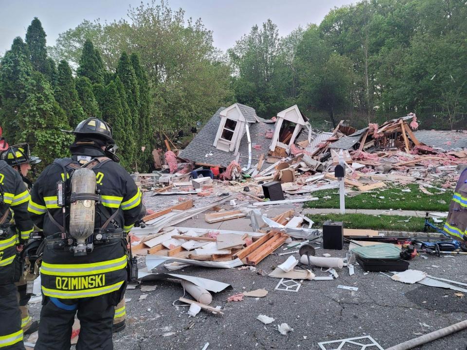 Authorities were investigating the cause of a home explosion in South River Thursday evening that left one man dead and another injured.