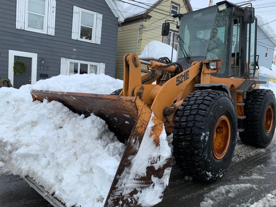 A wheel loader clears snow away in Sydney, N.S., on Feb. 6, 2024.