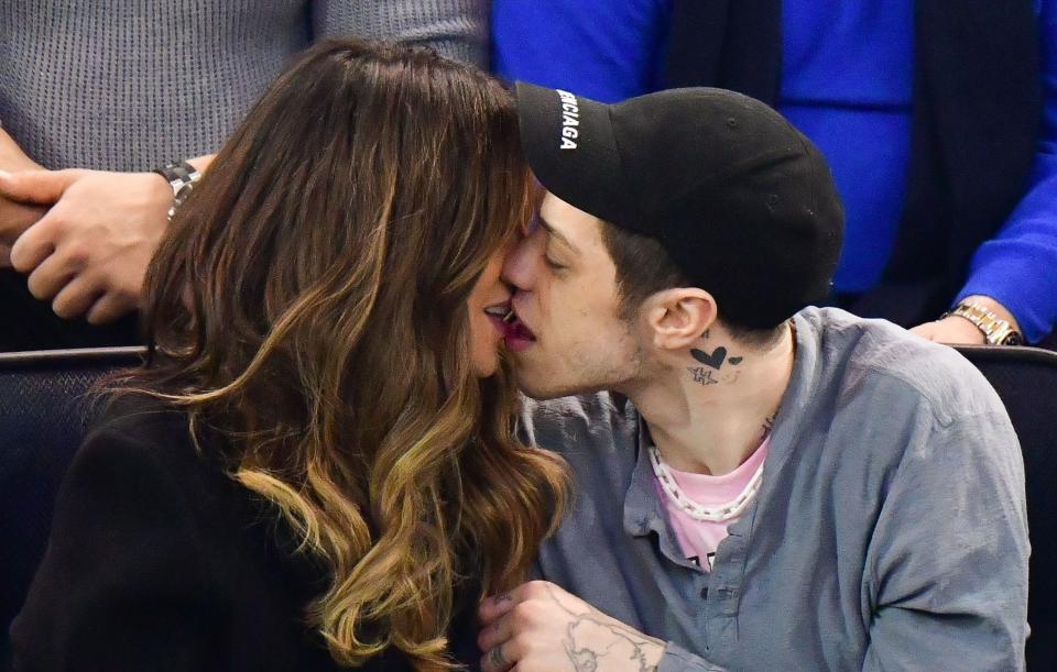 Kate and Pete making out in the stands of a hockey game