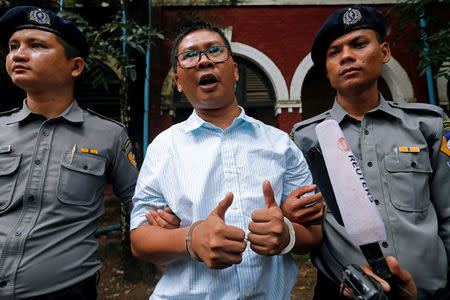 Detained Reuters journalist Wa Lone speaks to the media as he leaves Insein court in Yangon, Myanmar July 30, 2018. REUTERS/STRINGER