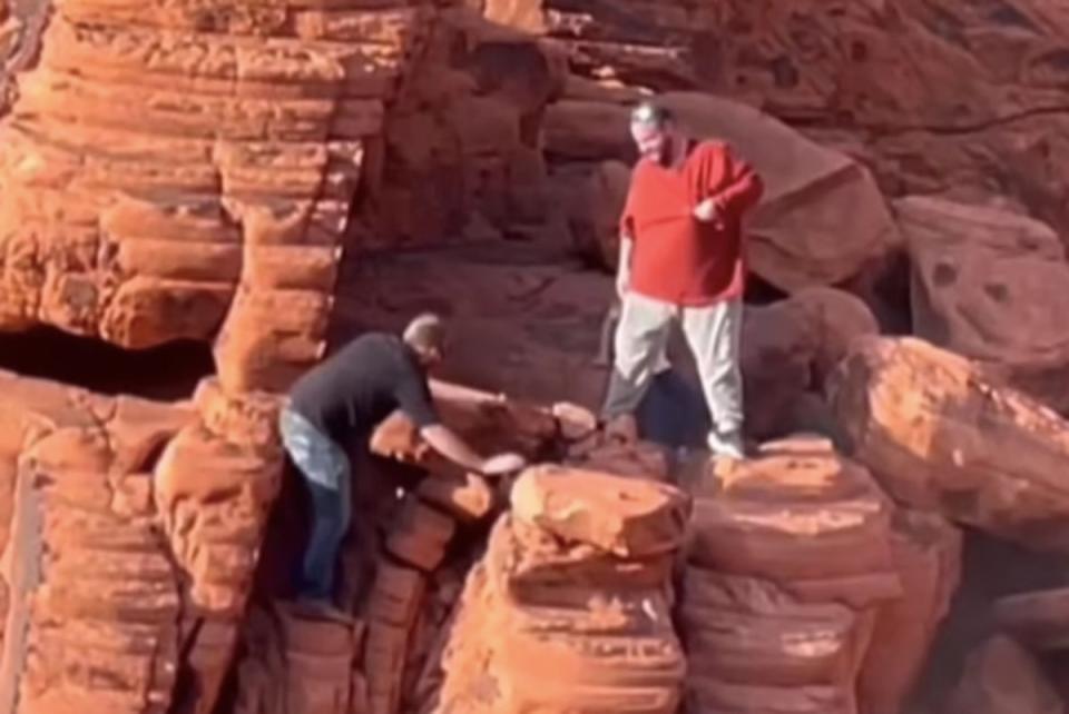 Video footage shows two visitors scaling russet-colored rock formations in Lake Mead National Park on 7 April, 2024 (Touronsofyellowstone via Instagram)