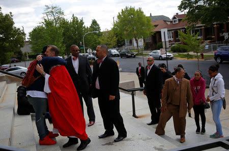 Parishioners line up to greet Father Michael Pfleger after a Sunday Service at Saint Sabina Church in Chicago, Illinois, U.S. May 15, 2016. REUTERS/Jim Young