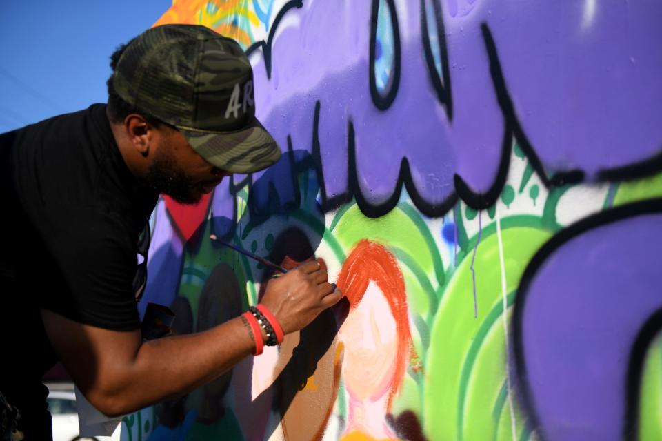 Jon Brick, 36, takes a break from being a full-time artist and art teacher in Baltimore to return to his roots in Salisbury, Maryland, and complete a painting at Mizzle Fest downtown on Saturday, Sept. 21, 2019. Brick, working for hours on the piece, said it was made to be donated.