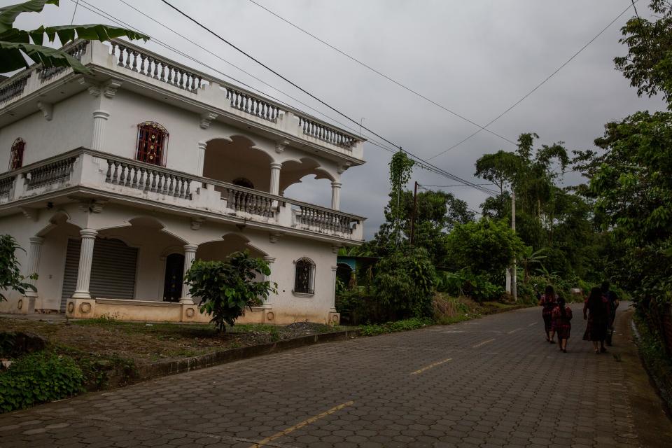 A home constructed with remittances from the U.S. contrasts with more modest homes in the village where Diego's family lives in Tzucubal.