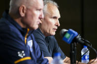 St. Louis Blues NHL hockey team head coach Craig Berube, rear, and general manager Doug Armstrong speak during a press conference in St. Louis, Wednesday, June 26, 2019. Berube, who led the franchise to its first Stanley Cup title this season, signed a three year contract with the team on Tuesday, officially removing his interim title. (Colter Peterson/St. Louis Post-Dispatch via AP)