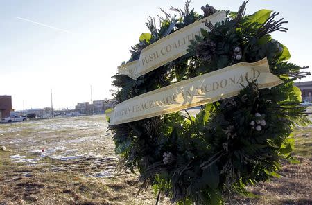 A wreath with the words "Rest In Peace Laquan McDonald" stands at the site where the 17-year-old McDonald was shot 16 times and killed by Chicago police officer Jason Van Dyke in an October 2014 incident on the west side of Chicago, November 24, 2015. REUTERS/Frank Polich