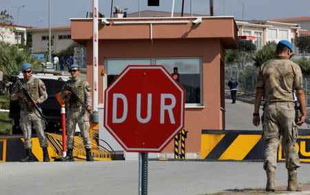 Soldiers stand guard at the entrance to the Aliaga Prison and Courthouse complex in Izmir, Turkey October 12, 2018. REUTERS/Umit Bektas