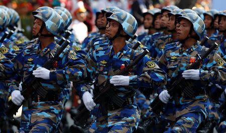 Soldiers hold rifles while marching during a celebration to mark Reunification Day in Ho Chi Minh city, Vietnam April 30, 2015. REUTERS/Kham