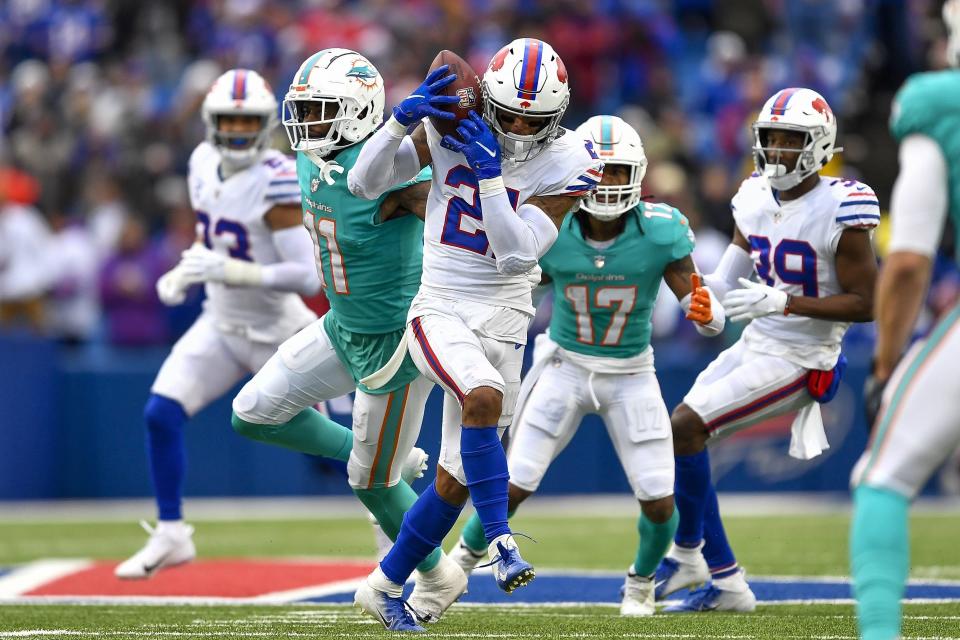 Buffalo Bills safety Jordan Poyer, center, intercepts a pass by Miami Dolphins quarterback Tua Tagovailoa during the second half of an NFL football game, Sunday, Oct. 31, 2021, in Orchard Park, N.Y. (AP Photo/Adrian Kraus)