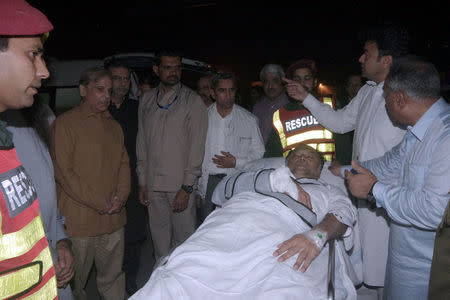 Officers and rescue workers move Pakistan's Interior Minister Ahsan Iqbal on a stretcher, after he was shot during a rally in Narowal and transported for medical attention to Lahore, Pakistan May 6, 2018. Directorate General Public Relations (DPGR) Punjab/Handout via REUTERS