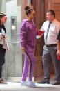 <p>In a purple hoodie and sweatpants, lavender socks, gray fur slides, hoop earrings, and sunglasses while out in New York. </p>