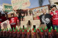 Sriracha hot sauce founder David Tran, second from right, with his workers and supporters protest ahead of the city council meeting in Irwindale, Calif., Wednesday, April 23, 2014. The Irwindale City Council has declared that the factory that produces the popular Sriracha hot sauce is a public nuisance. (AP Photo/Damian Dovarganes)