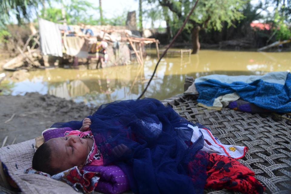 Newborn baby Yasmeem sleeps on a cot at her flood-damaged house on the outskirts of Sukkur, Sindh province (Getty Images)