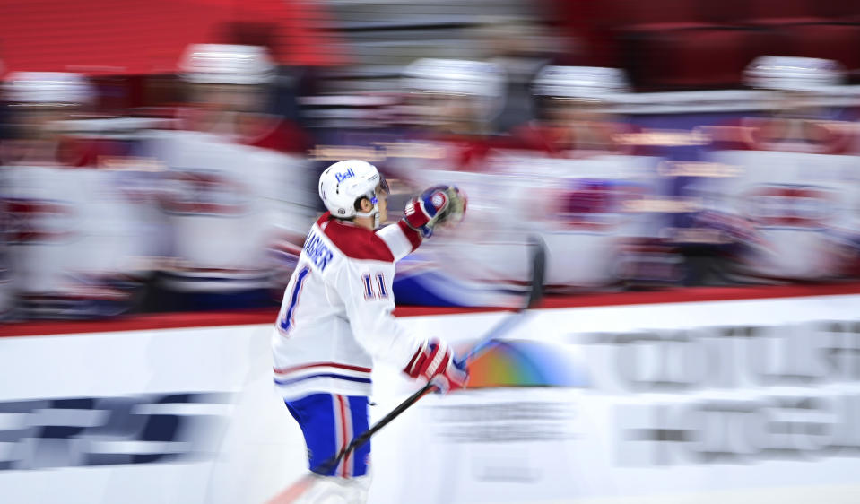 Montreal Canadiens' Brendan Gallagher (11) celebrates a goal against the Ottawa Senators as he skates past the bench during the third period of an NHL hockey game Thursday, April 1, 2021, in Ottawa, Ontario. (Sean Kilpatrick/The Canadian Press via AP)