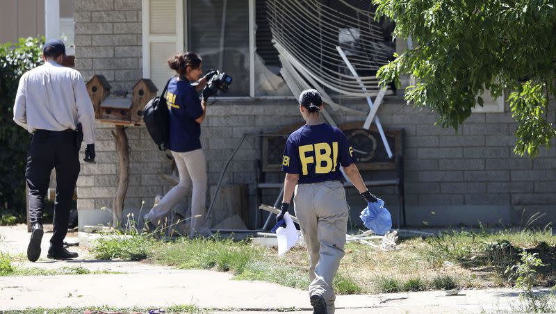Law enforcement agents investigate at the home of Craig Deleeuw Robertson, who was shot and killed by FBI agents in Provo on Wednesday, Aug. 9, 2023. Robertson posted threatening comments about President Joe Biden hours before the president was scheduled to visit Utah.
