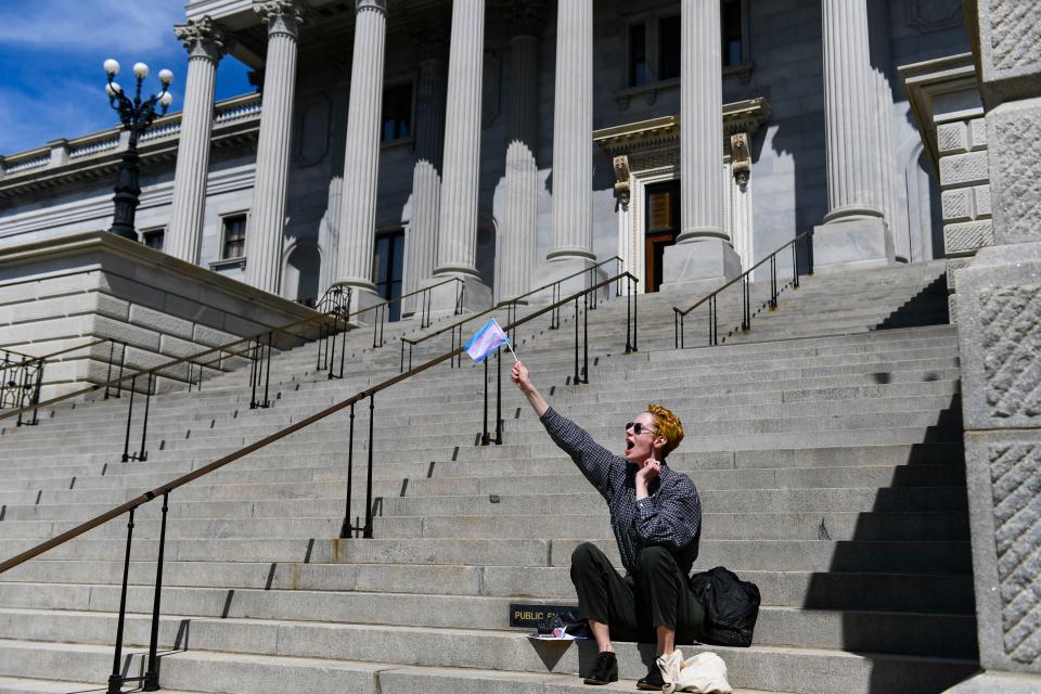 Ansley Zdonek, 25, of Greenville, cheers as they raise a flag representing the transgender community during a gathering outside of the S.C. Statehouse on Wednesday, March 29, 2023.