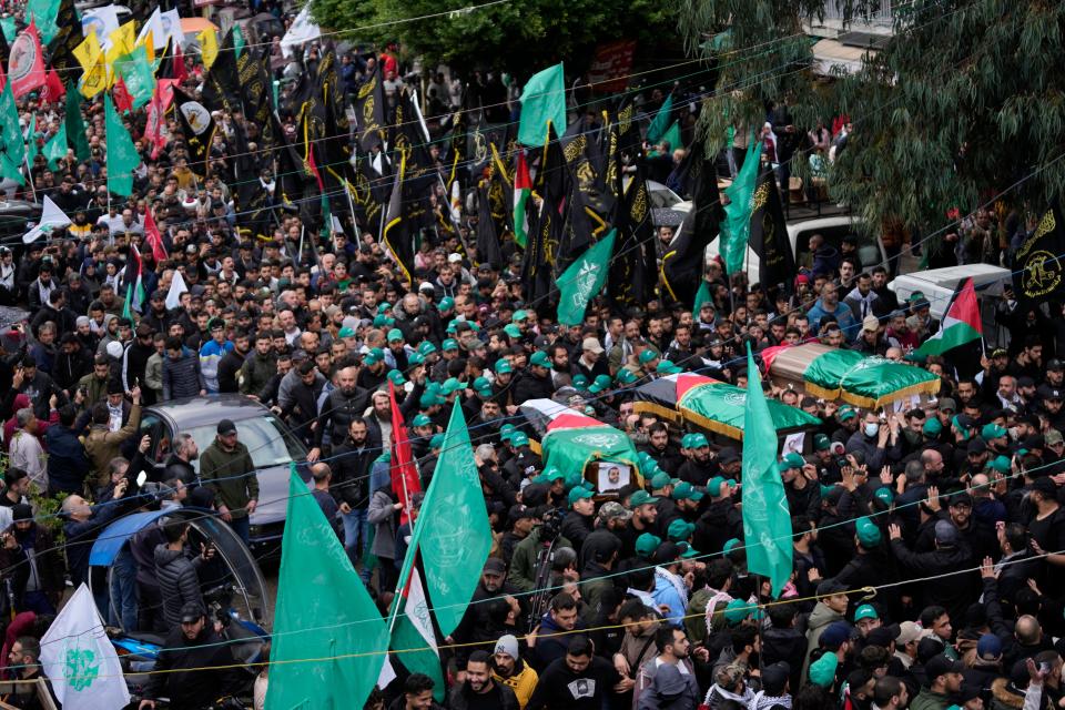 People attend the funeral for Saleh Arouri, one of the top Hamas commanders, and two other Hamas members in Beirut on Jan. 4, 2023.