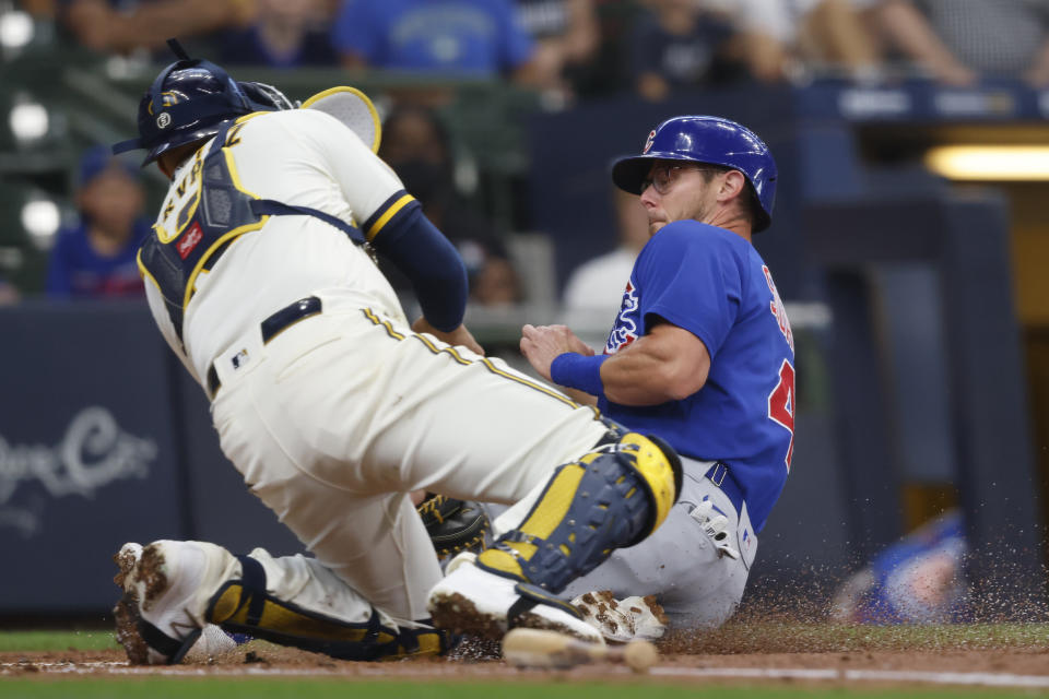 Chicago Cubs' Eric Sogard, right, is tagged out at home plate by Milwaukee Brewers catcher Omar Narvaez during the first inning of a baseball game Wednesday, June 30, 2021, in Milwaukee. (AP Photo/Jeffrey Phelps)