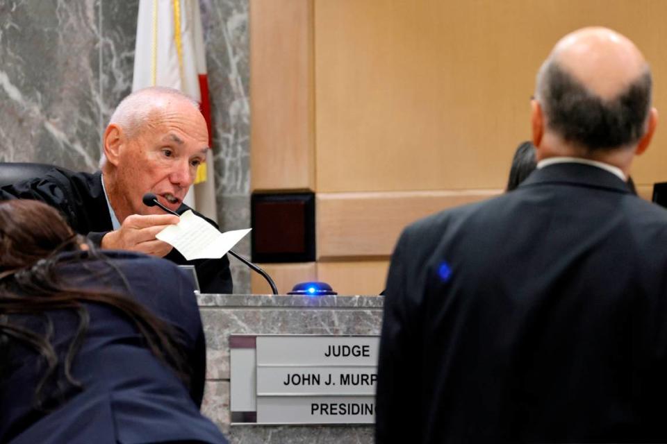 Judge John Murphy shows attorneys a note from a juror in the trial of Jamell Demons, better known as rapper YNW Melly, at the Broward County Courthouse in Fort Lauderdale on Friday, July 21, 2023. Demons, 22, is accused of killing two fellow rappers and conspiring to make it look like a drive-by shooting in October 2018. (Amy Beth Bennett / South Florida Sun Sentinel)