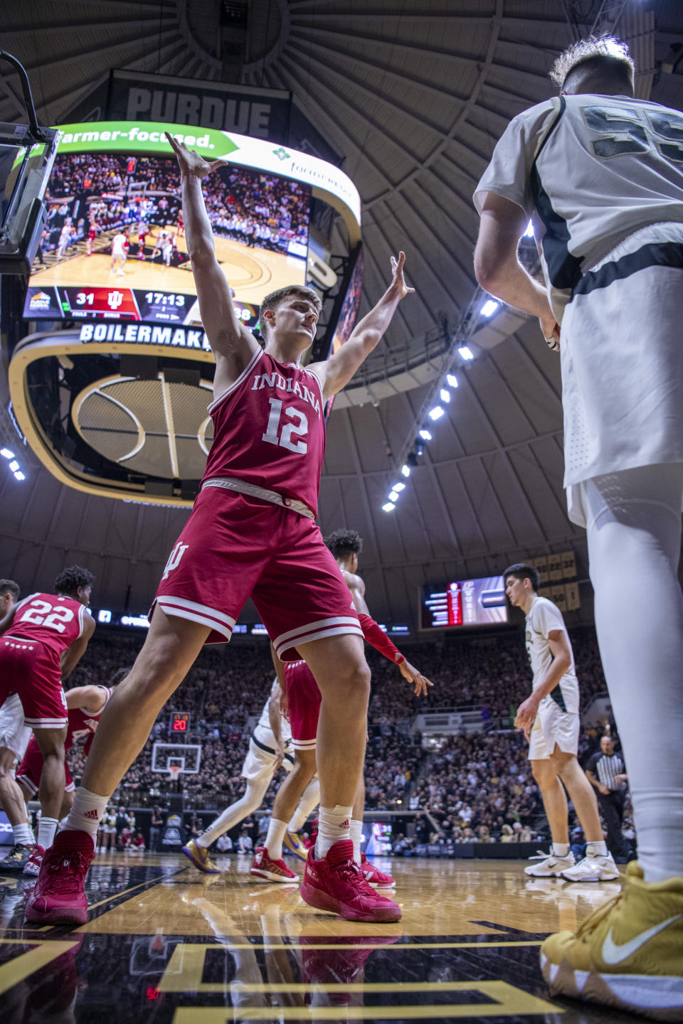 Indiana forward Miller Kopp (12) defends Purdue guard Sasha Stefanovic (55) as Stefanovic works to in-bound the ball during the second half of an NCAA college basketball game, Saturday, March 5, 2022, in West Lafayette, Ind. (AP Photo/Doug McSchooler)