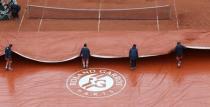 Tennis - French Open - Roland Garros - Paris, France - 22/05/16 Court workers remove tarpaulin after rain. REUTERS/Pascal Rossignol