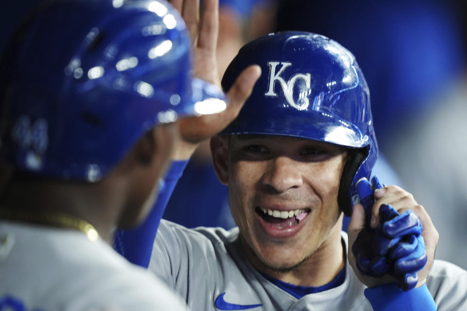 Kansas City Royals' Freddy Fermin, right, celebrates in the dugout after scoring against the Toronto Blue Jays during the seventh inning of a baseball game Friday, Sept. 8, 2023, in Toronto. (Nathan Denette/The Canadian Press via AP)