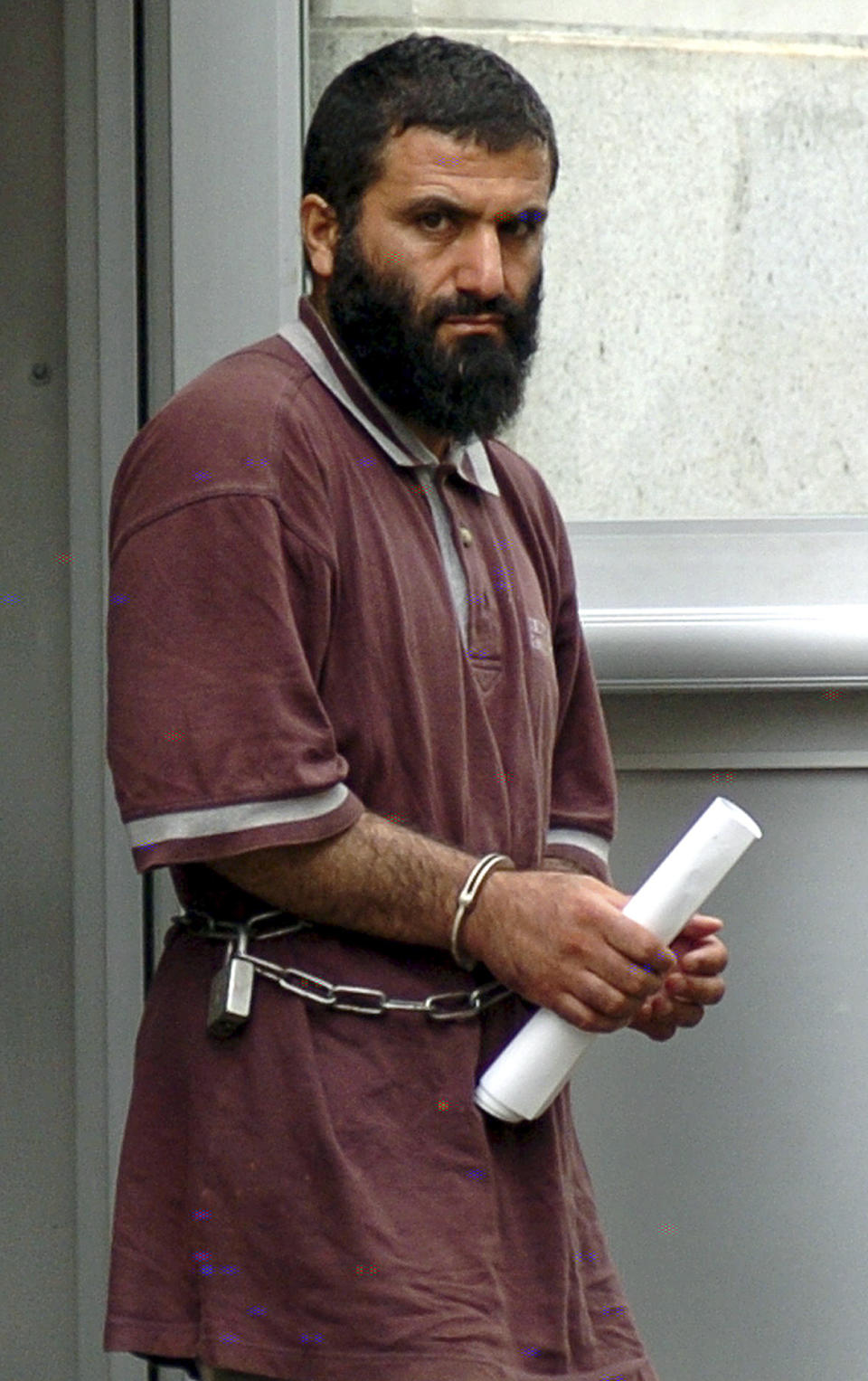 FILE - Yassin Aref walks out of the Federal Building on Thursday, Aug. 5, 2004, in Albany, N.Y. after his arraignment after federal agents and local Albany police raided the Masjid As-Salam mosque where Aref was an Imam. The government sting was launched in the anxious years after 9/11 to catch potential terrorists. But critics accused FBI agents of using a manipulative informant to ensnare people. In a scathing ruling, a judge last week said the "real lead conspirator was the United States."(AP Photo/Tim Roske, FILE)