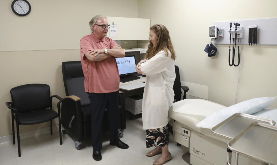 In this July 9, 2019 photo, Dr. Jori Fleisher, neurologist, examines Thomas Doyle, 66, at the Rush University Medical Center in Chicago. Doyle, 66, hopes blood tests may someday replace the invasive diagnostic testing he endured to be diagnosed 4.5 years ago with Lewy body dementia. (AP Photo/Teresa Crawford)