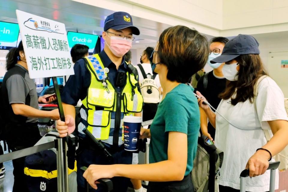 治安機關將矛頭指向台灣受害者被販運到國外，警察在機場舉牌勸導。(中央社，資料照)