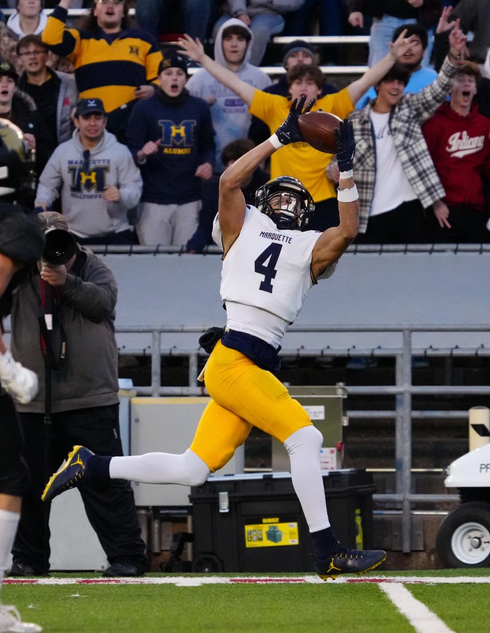 Marquette's Cam Russell (4) pulls in a pass for a 44-yard touchdown reception to get the scoring started for the Hilltoppers on Friday against Franklin in the Division 1 state title game on Friday at Camp Randall Stadium.