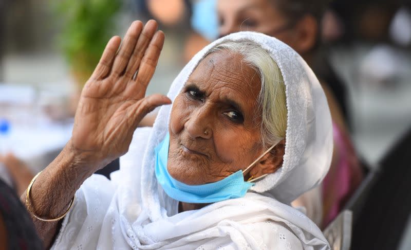 Bilkis Dadi, who recently featured in TIME magazine's 100 most influential 2020, waves for a photograph during a felicitation ceremony at Press club on September 29, 2020 in New Delhi.