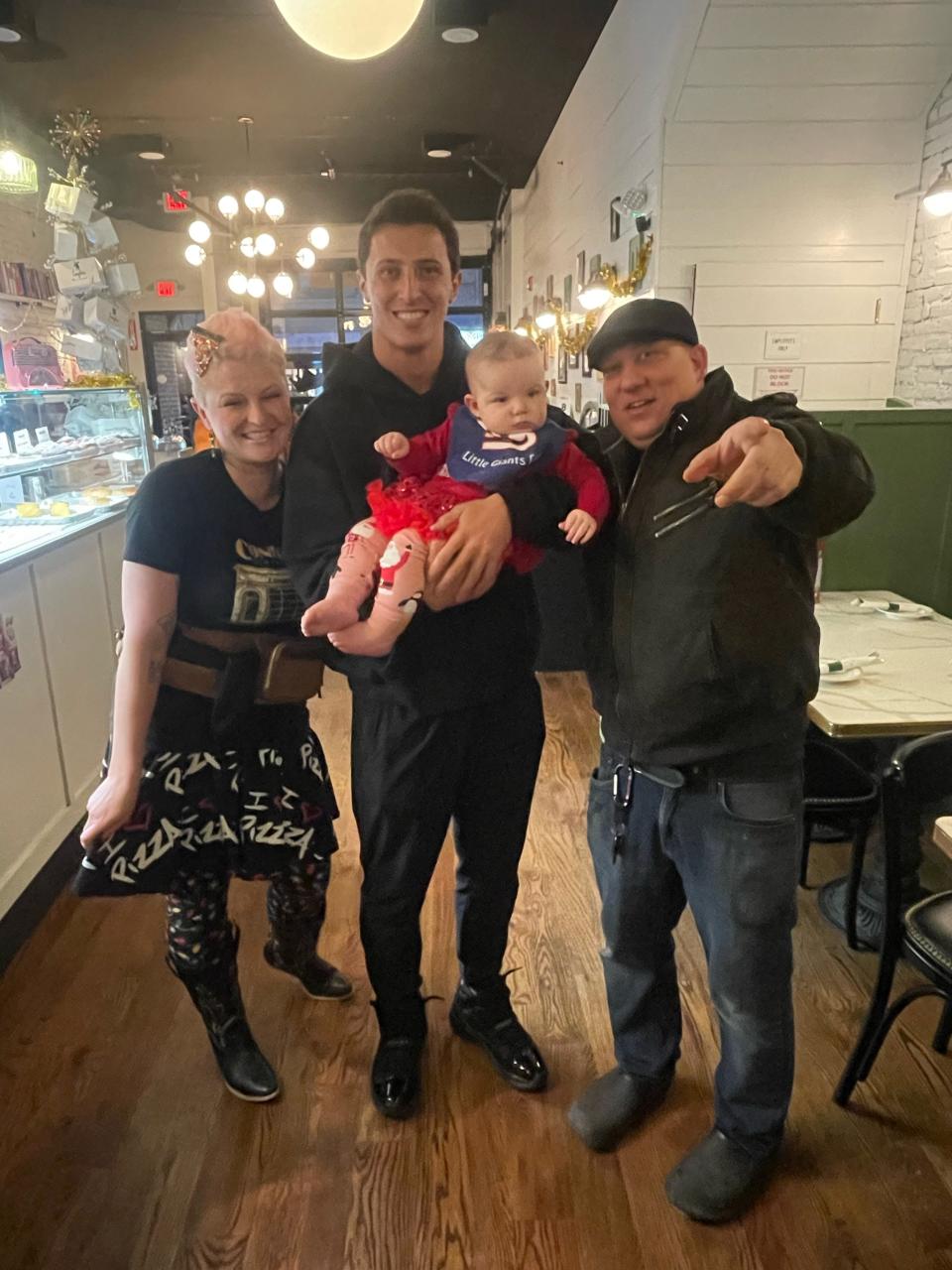Giants quarterback Tommy DeVito holding Penelope Luciana Coniglio and flanked by Nino Coniglio and Shealyn Coniglio at Coniglio's Old Fashioned restaurant in Morristown on Tuesday, Dec. 19, 2023.