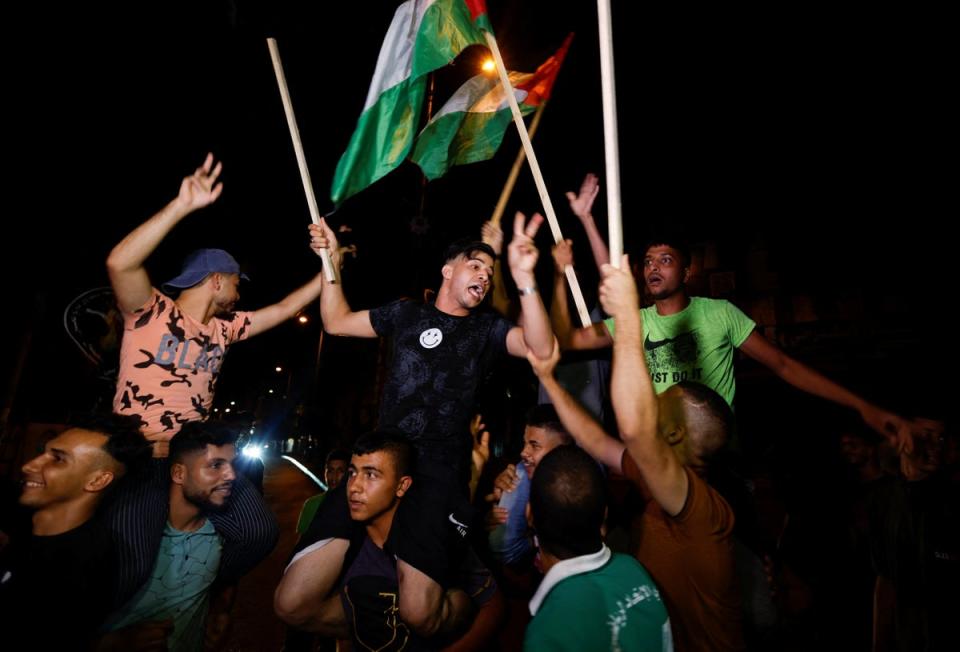 Palestinians celebrate on a street after a ceasefire was announced, in Gaza City (REUTERS)