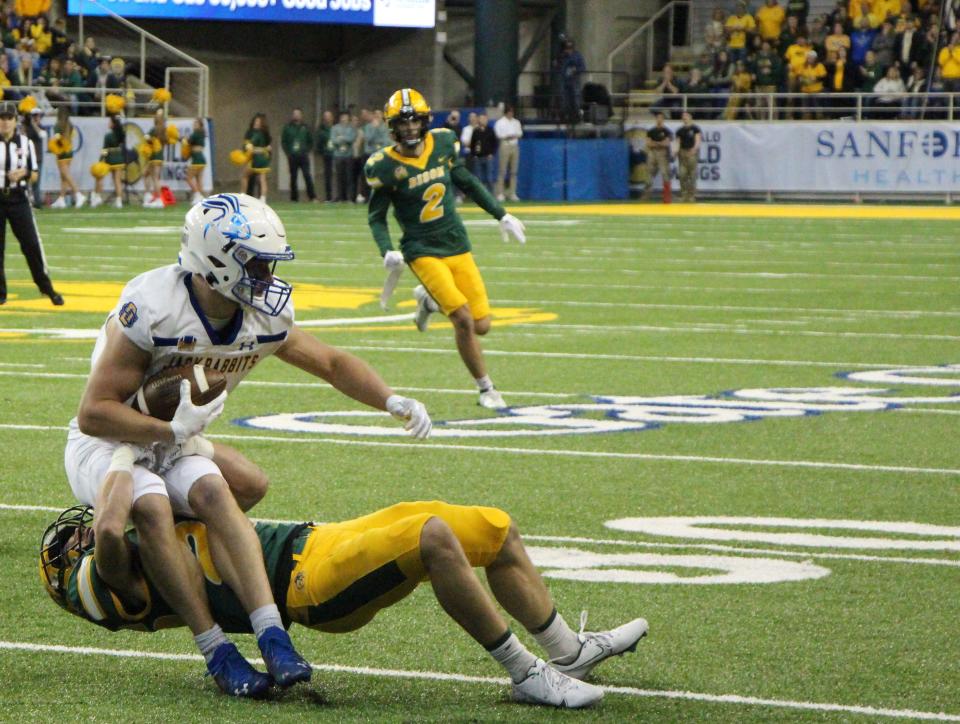 South Dakota State's Jadon Janke is brought down by North Dakota State's Michael Tutsie in the first quarter of Saturday's game at the Fargodome.