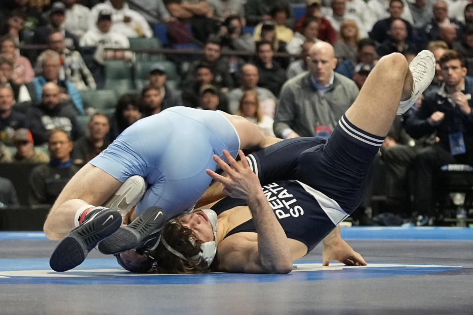 North Carolina's Austin O'Connor, left, wrestles Penn State's Levi Haines, right, in the 157 lb. championship match the NCAA Wrestling Championships, Saturday, March 18, 2023, in Tulsa, Okla. (AP Photo/Sue Ogrocki)