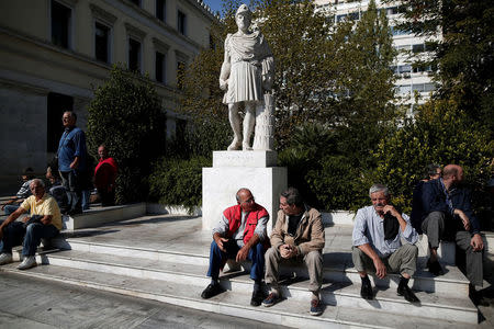 Greek pensioners sit next to a statue of ancient Athenian politician and general Pericles during a demonstration against planned pension cuts in Athens, Greece, October 3, 2017. REUTERS/Alkis Konstantinidis