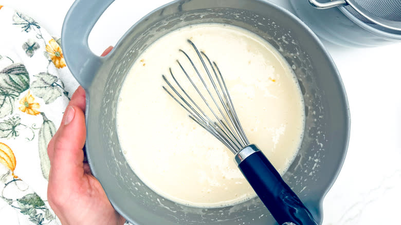 whisking custard ingredients in bowl