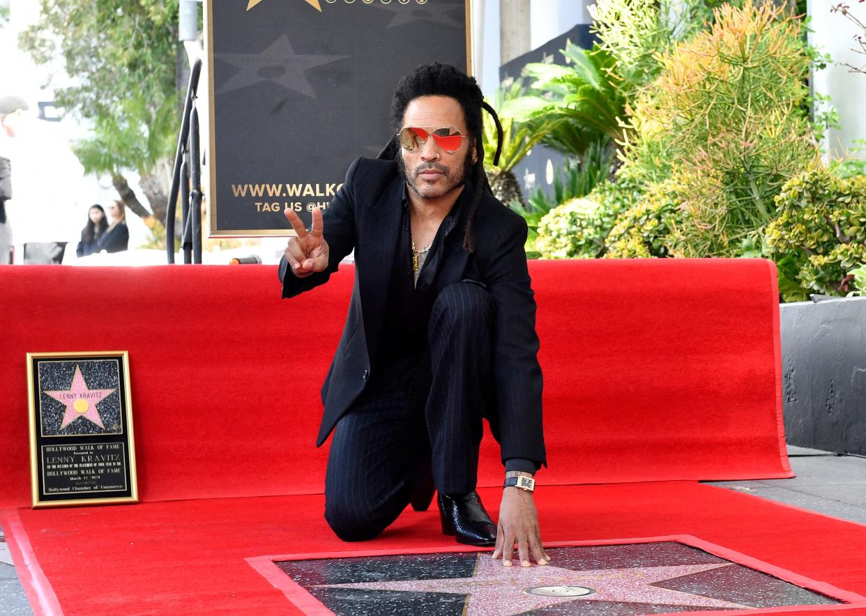 Lenny Kravitz poses on his newly unveiled star during his Walk of Fame ceremony in Los Angeles, California, on March 12, 2024.
